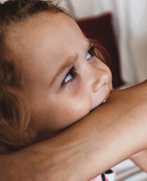 A child biting someone's arm