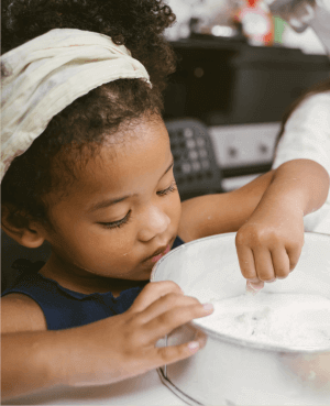 Young child baking a cake