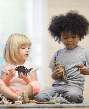 Two toddlers playing with toys