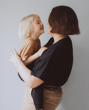 A mother and child smiling at each other