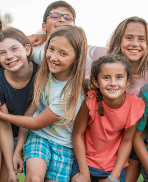 A group of 6-12 year old kids smiling