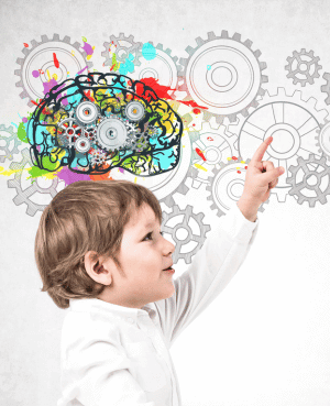 Young boy pointing at colorful gears and brain illustration, symbolizing child brain development and neuroscience.