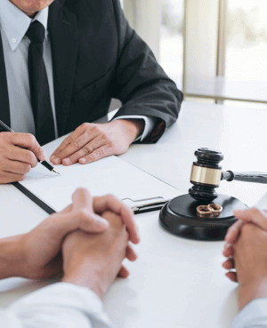 Divorce attorney explaining custody and co-parenting legal process with couple.