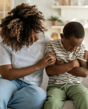 Parent comforting a child who feels upset after a difficult moment.