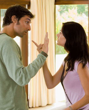 Couple arguing during a high-conflict divorce discussion.