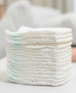 Stack of diapers representing toddler diaper changes, potty resistance, and the in-between stage of toilet learning.