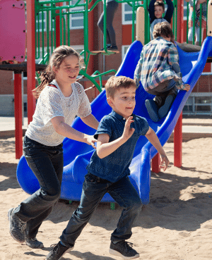 Children running on a playground, showing peer boundaries and self-advocacy for sensitive kids.