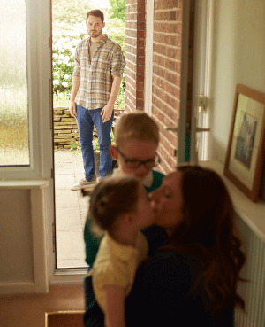 Parents separating while a caregiver comforts a child, representing child custody and family transition during divorce.