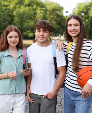Group of teens together outdoors, illustrating friendship, belonging, social connection, and adolescent mental health.