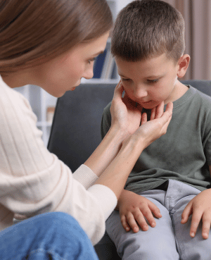 Parent gently comforting a worried child, representing support for intrusive thoughts and childhood anxiety.
