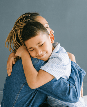 Parent hugging a young child, representing resonance, emotional safety, and secure attachment.